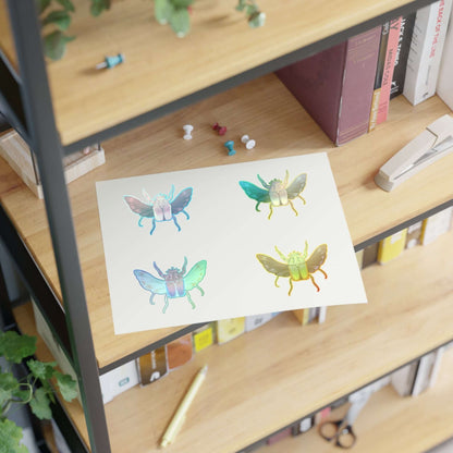 Sheet of die-cut colorful insect stickers, four butterfly-like bugs on white backing.