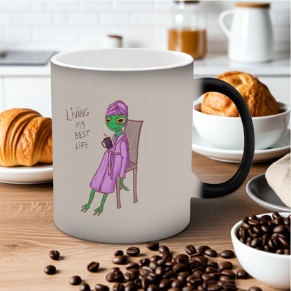 White mug with black handle, purple frog graphic and &